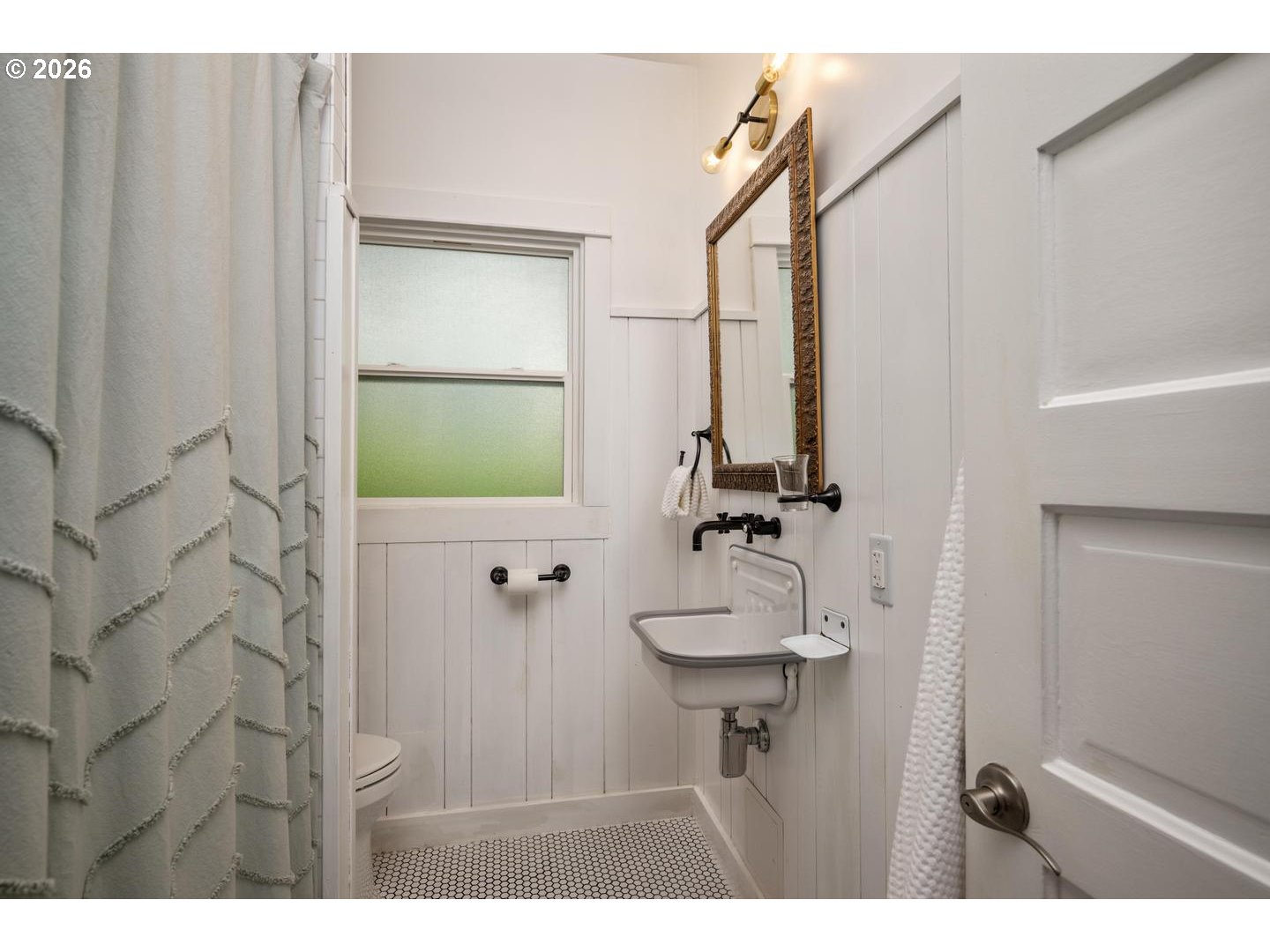3725 North Baldwin Street Portland, OR 97217 - Photo 16 of 43 a bathroom with a sink and mirror