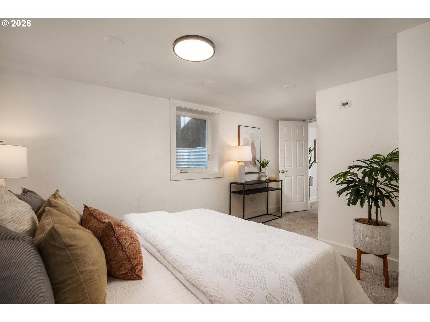 3725 North Baldwin Street Portland, OR 97217 - Photo 30 of 43 a bedroom with a bed and a potted plant