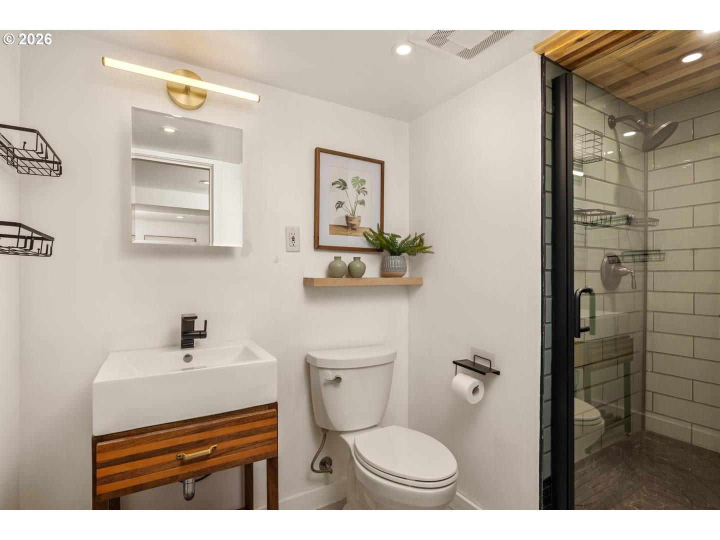 3725 North Baldwin Street Portland, OR 97217 - Photo 31 of 43 a bathroom with a toilet a sink and mirror