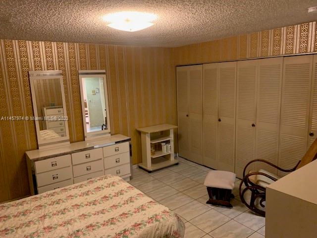 Hialeah Hialeah, FL 33012 - Photo 15 of 18 a bedroom with a bed and a dresser