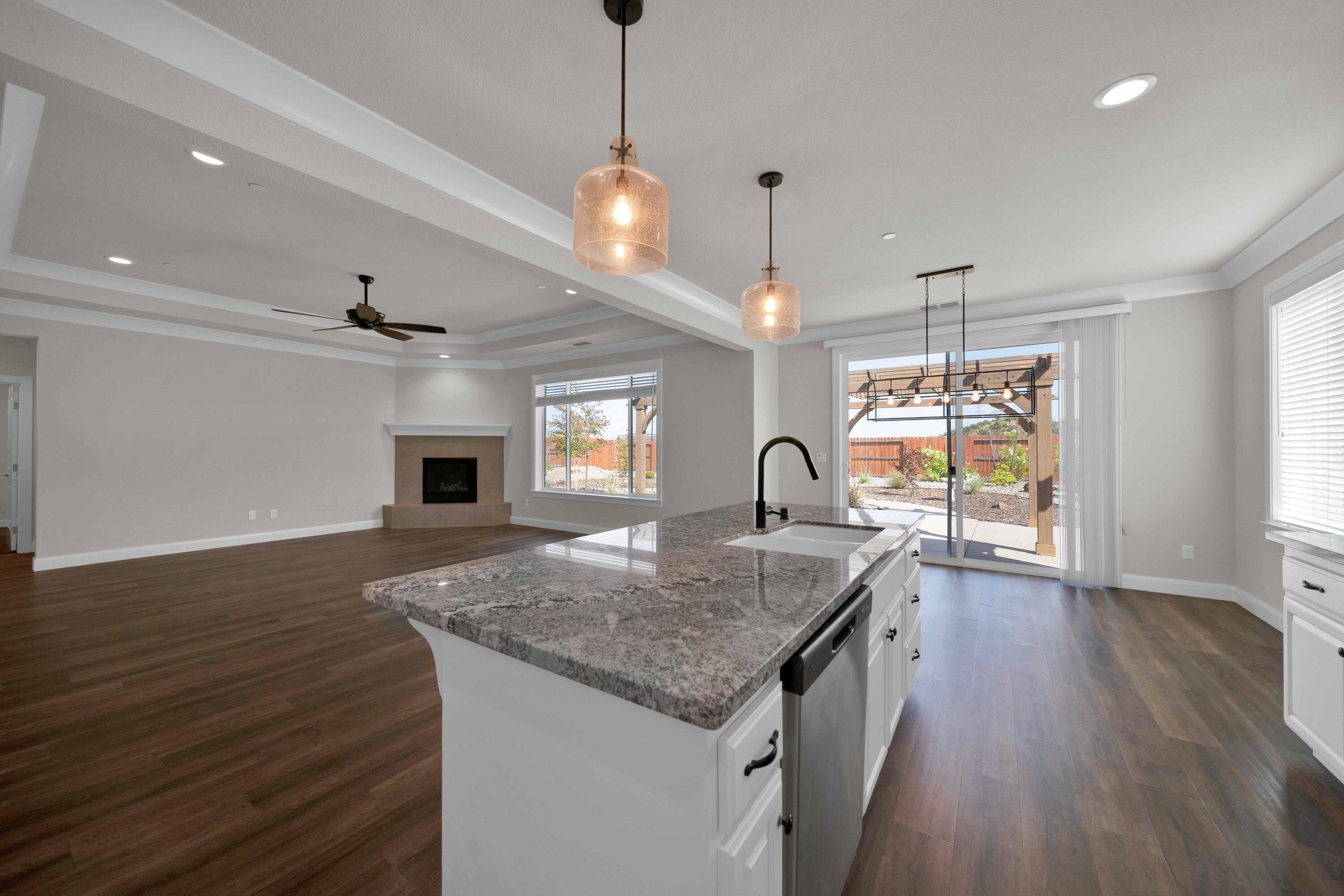 4771 Lower Springs Road Redding, CA 96001 - Photo 9 of 34 a kitchen with granite countertop center island wooden floor appliances and a window