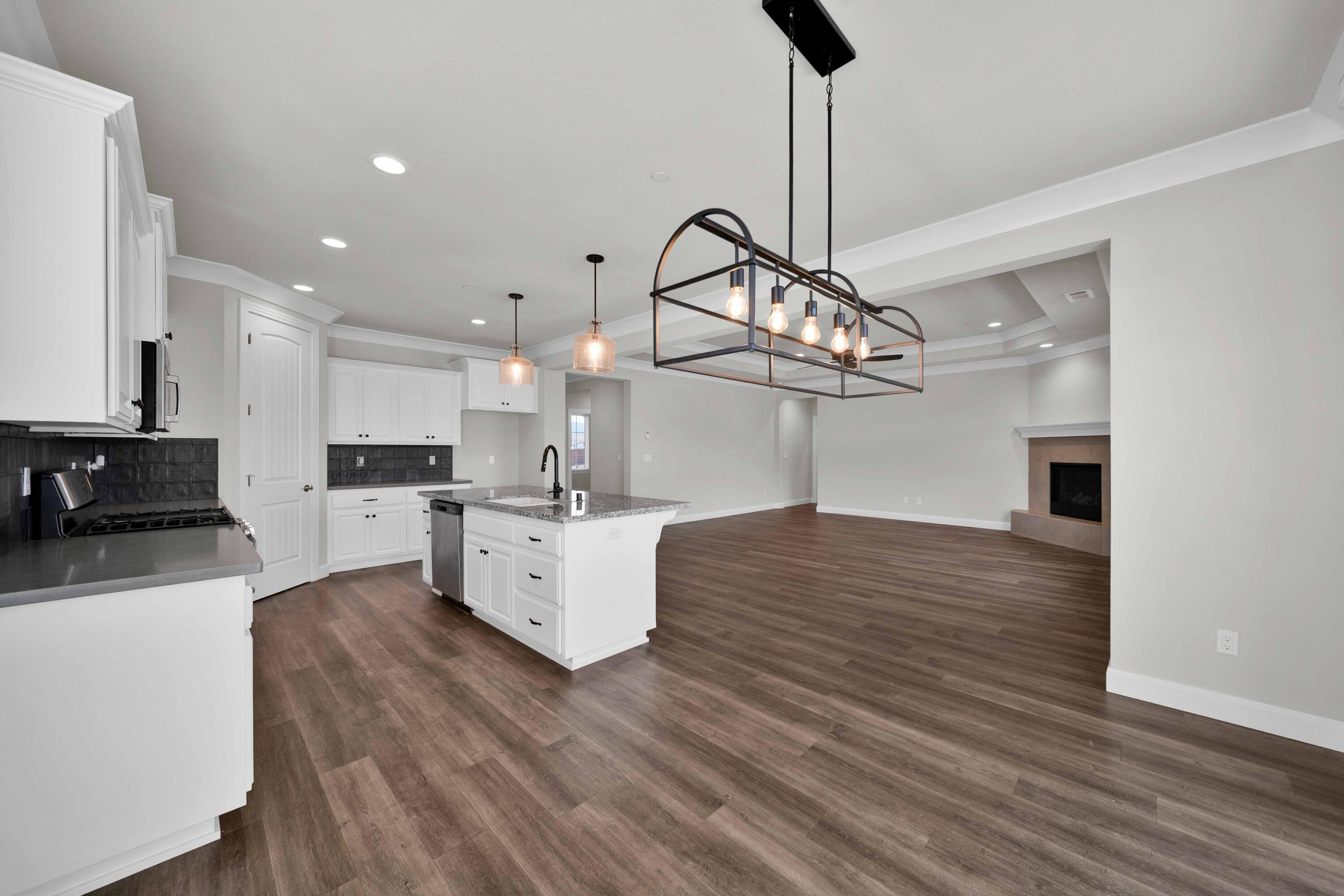 4771 Lower Springs Road Redding, CA 96001 - Photo 10 of 34 a kitchen with stainless steel appliances granite countertop a wooden floor sink and white cabinets