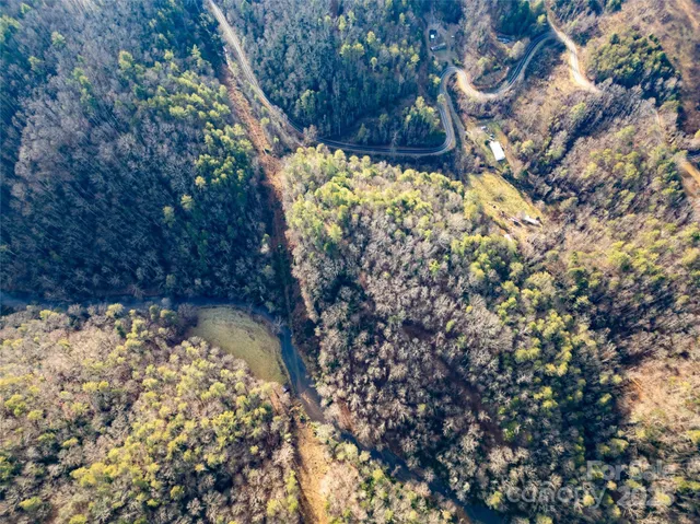 a view of a yard with wooden fence