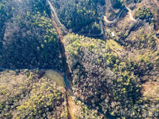 a view of a yard with wooden fence