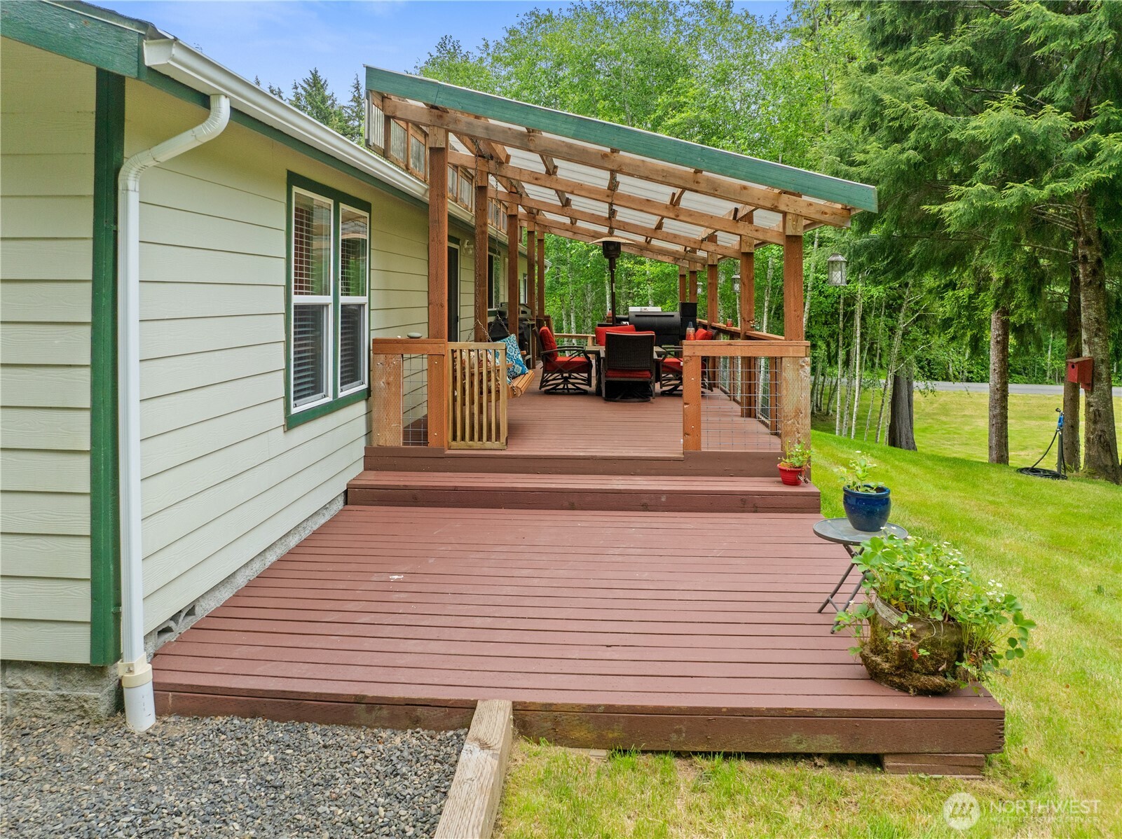 132 River Park Road Forks, WA 98331 - Photo 31 of 40 a view of a patio with table and chairs with wooden floor and fence