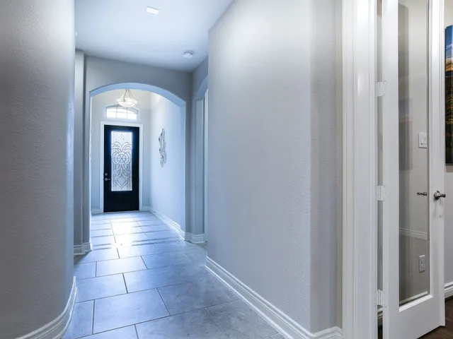 a view of a hallway with a wooden door