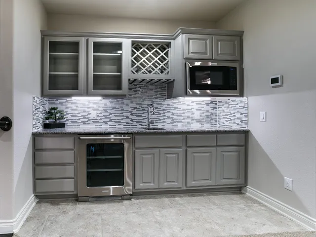 a bathroom with a granite countertop toilet sink and mirror
