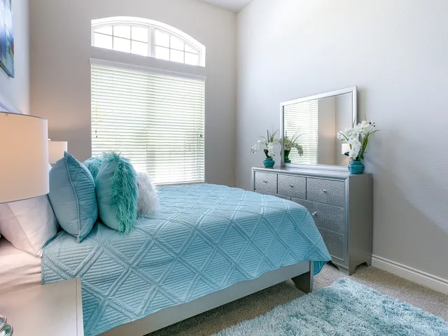 a bedroom with a bed and a window