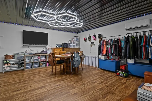 a spacious bedroom with a bed a table window and a couch