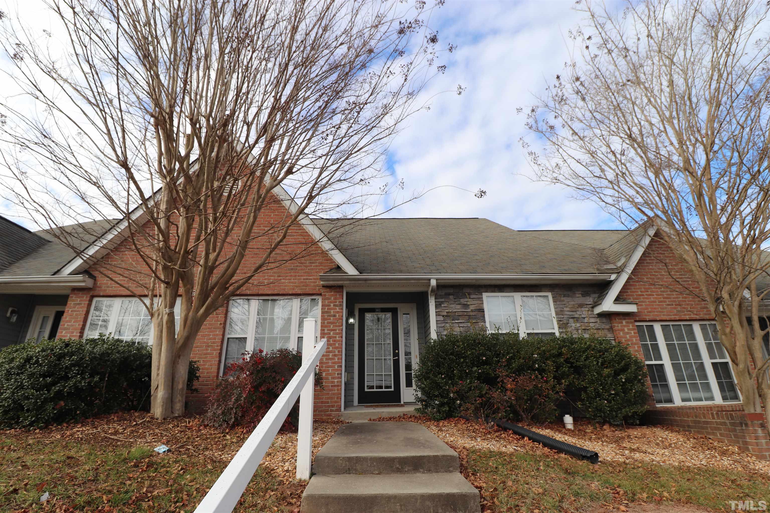 11301 Clubhaven Place, Unit 102 Raleigh, NC 27617 - Photo 1 of 53 a front view of a house with a garden