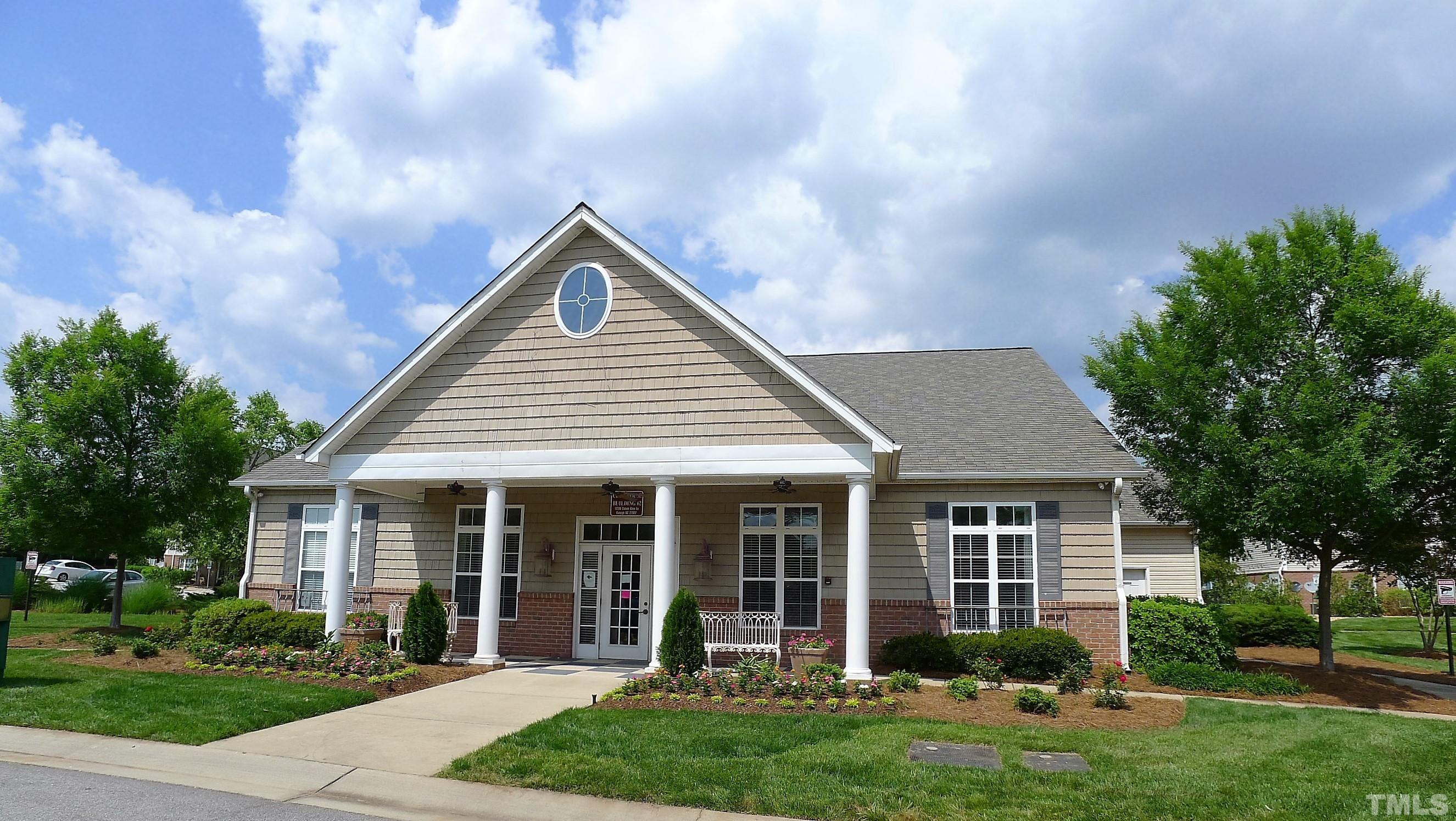 11301 Clubhaven Place, Unit 102 Raleigh, NC 27617 - Photo 2 of 53 a front view of a house with a yard and potted plants