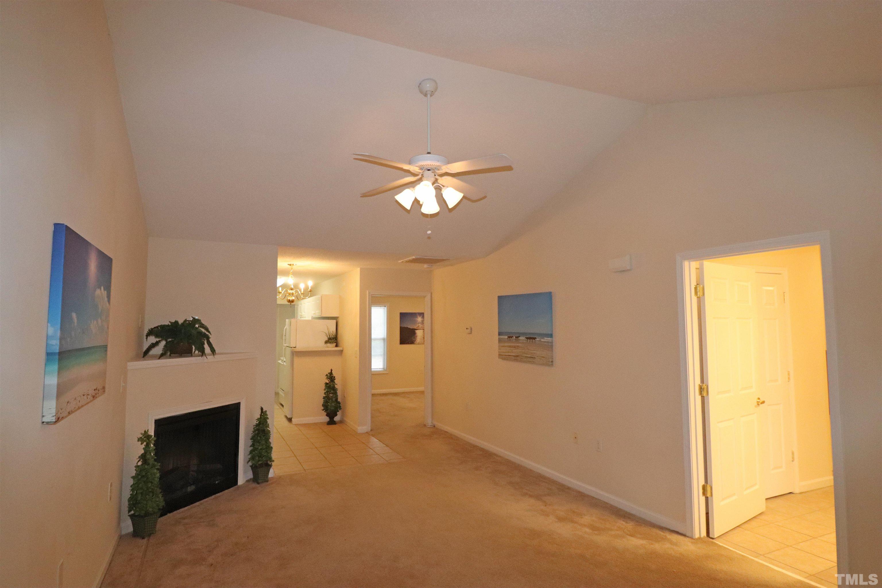 11301 Clubhaven Place, Unit 102 Raleigh, NC 27617 - Photo 14 of 53 a living room with furniture and a chandelier