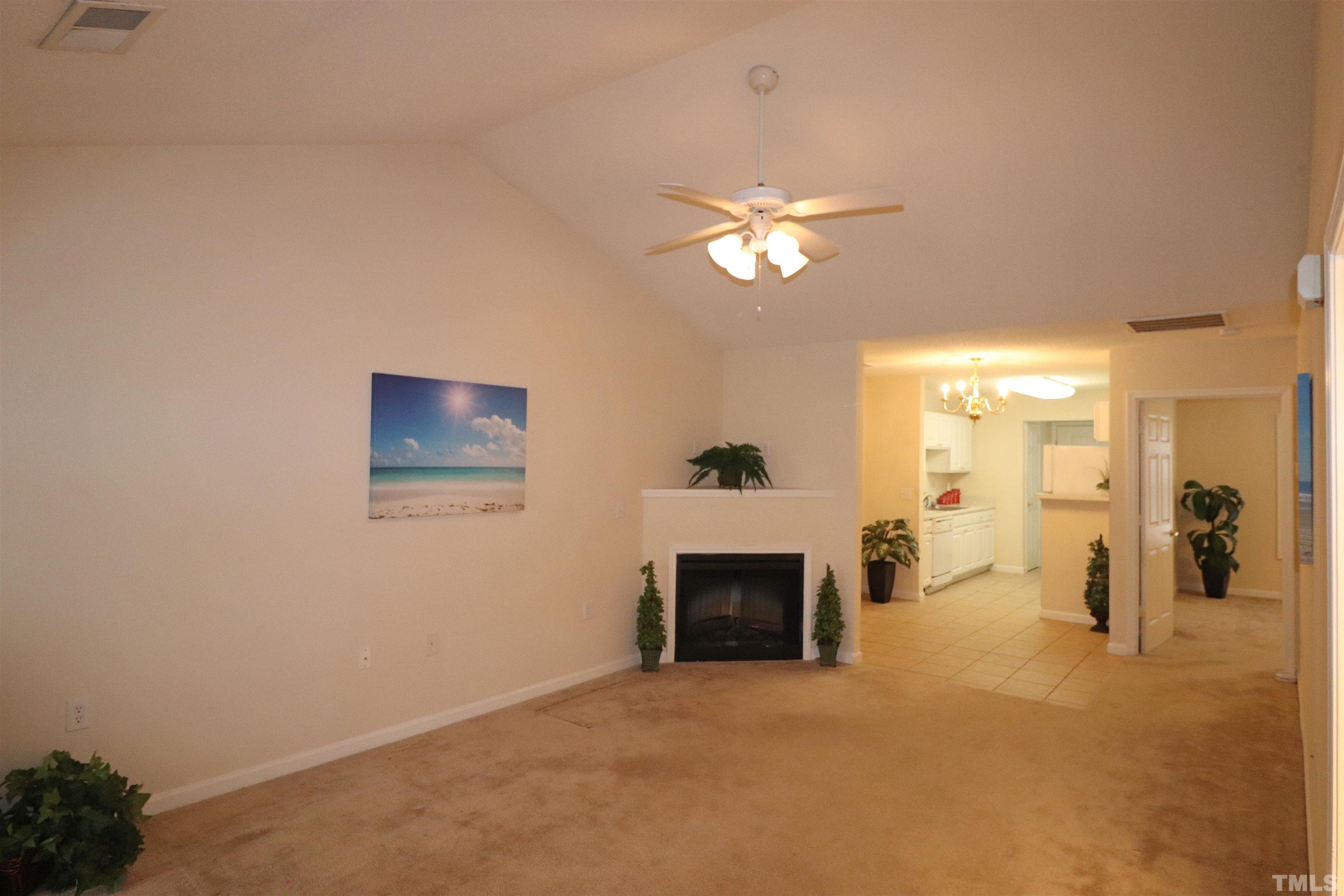 11301 Clubhaven Place, Unit 102 Raleigh, NC 27617 - Photo 15 of 53 a view of empty room with a fireplace and fan