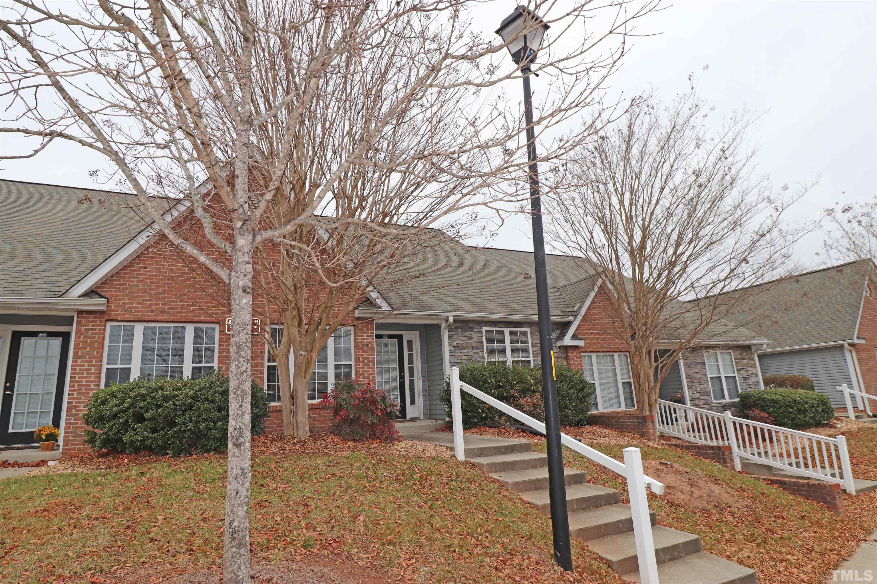 11301 Clubhaven Place, Unit 102 Raleigh, NC 27617 - Photo 17 of 53 a white house that has tree in front of it