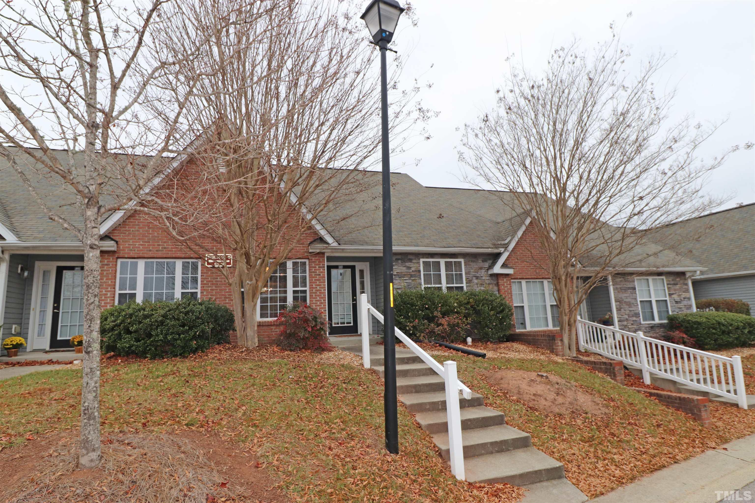 11301 Clubhaven Place, Unit 102 Raleigh, NC 27617 - Photo 18 of 53 a wooden bench sitting in front of house