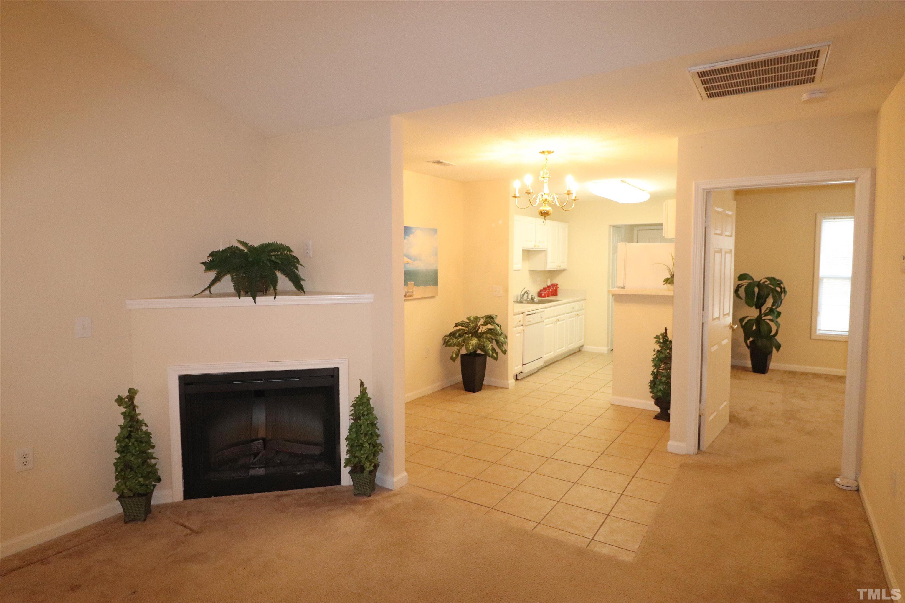 11301 Clubhaven Place, Unit 102 Raleigh, NC 27617 - Photo 20 of 53 a view of a livingroom with a fireplace and a workspace
