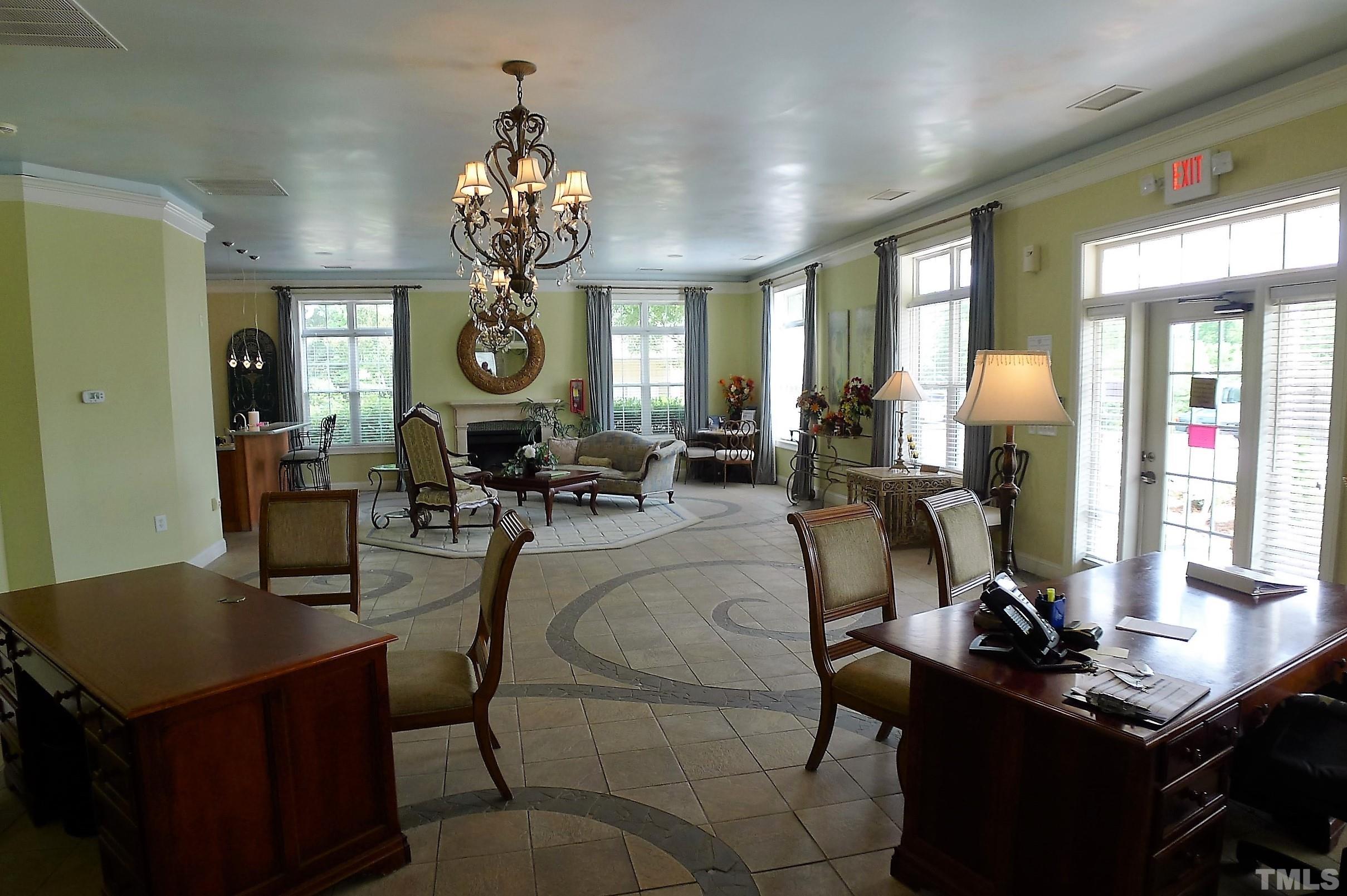 11301 Clubhaven Place, Unit 102 Raleigh, NC 27617 - Photo 3 of 53 a living room with furniture a chandelier and a large window