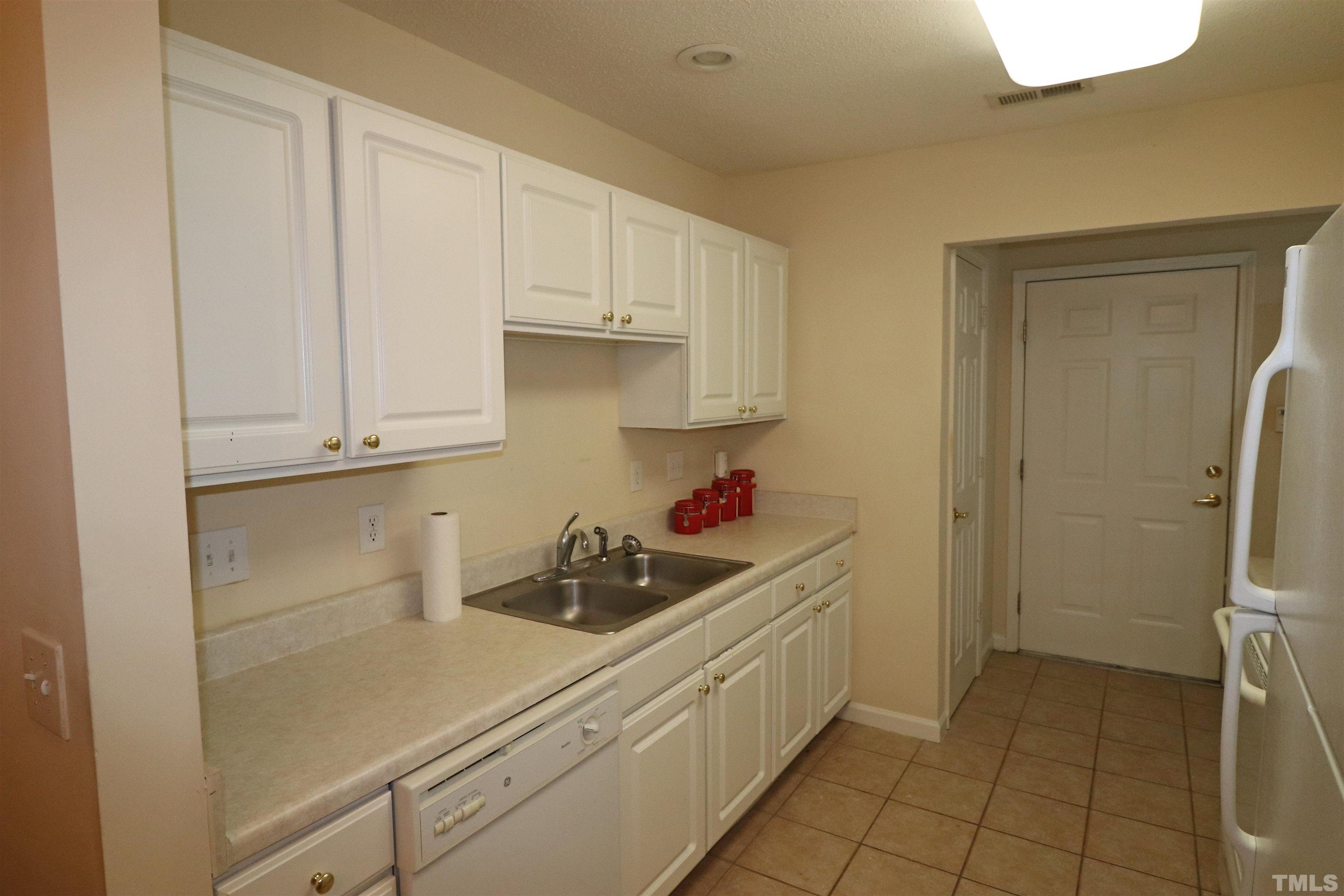 11301 Clubhaven Place, Unit 102 Raleigh, NC 27617 - Photo 25 of 53 a kitchen with a sink and cabinets