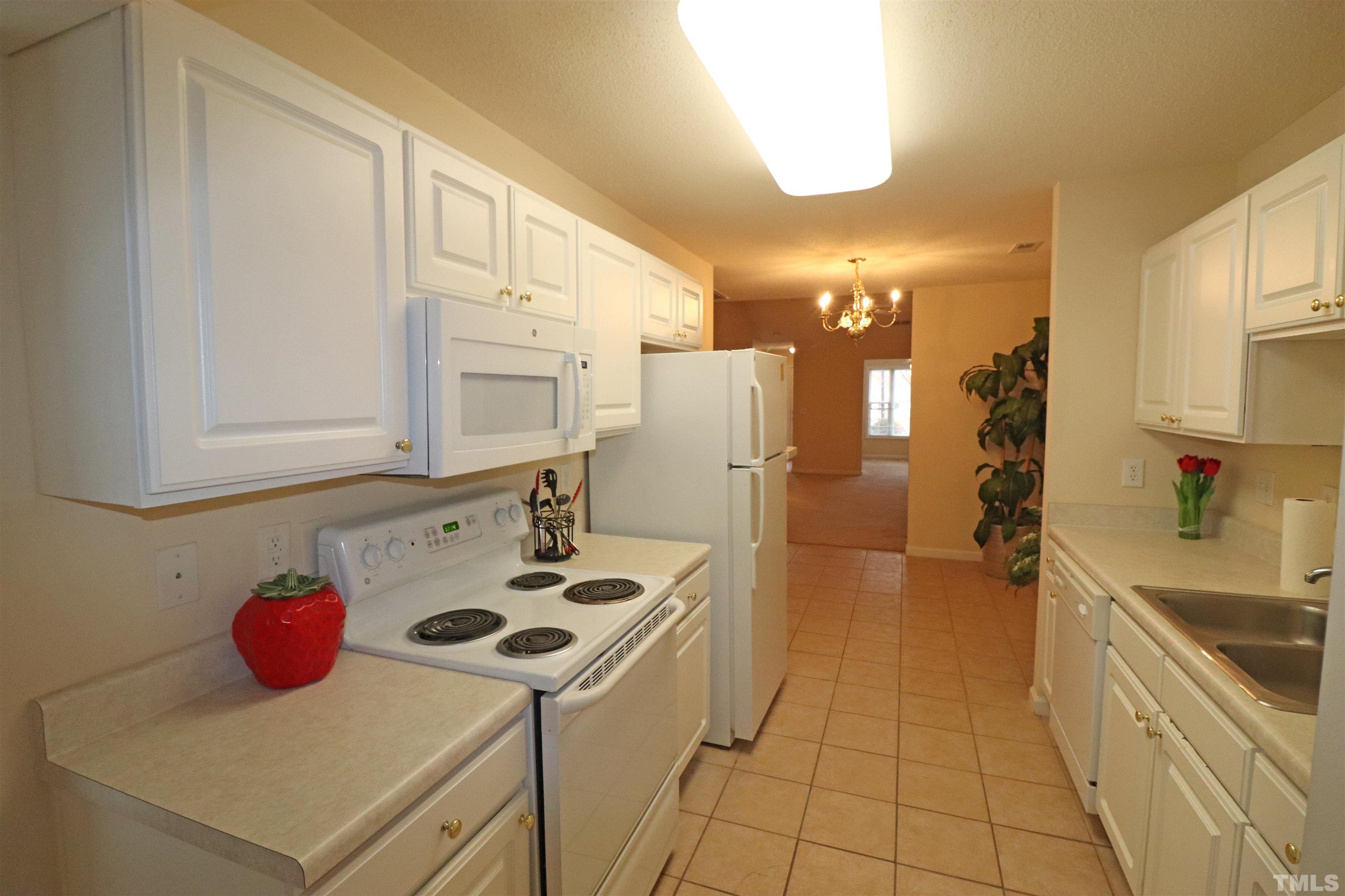 11301 Clubhaven Place, Unit 102 Raleigh, NC 27617 - Photo 28 of 53 a kitchen with a sink a stove and refrigerator