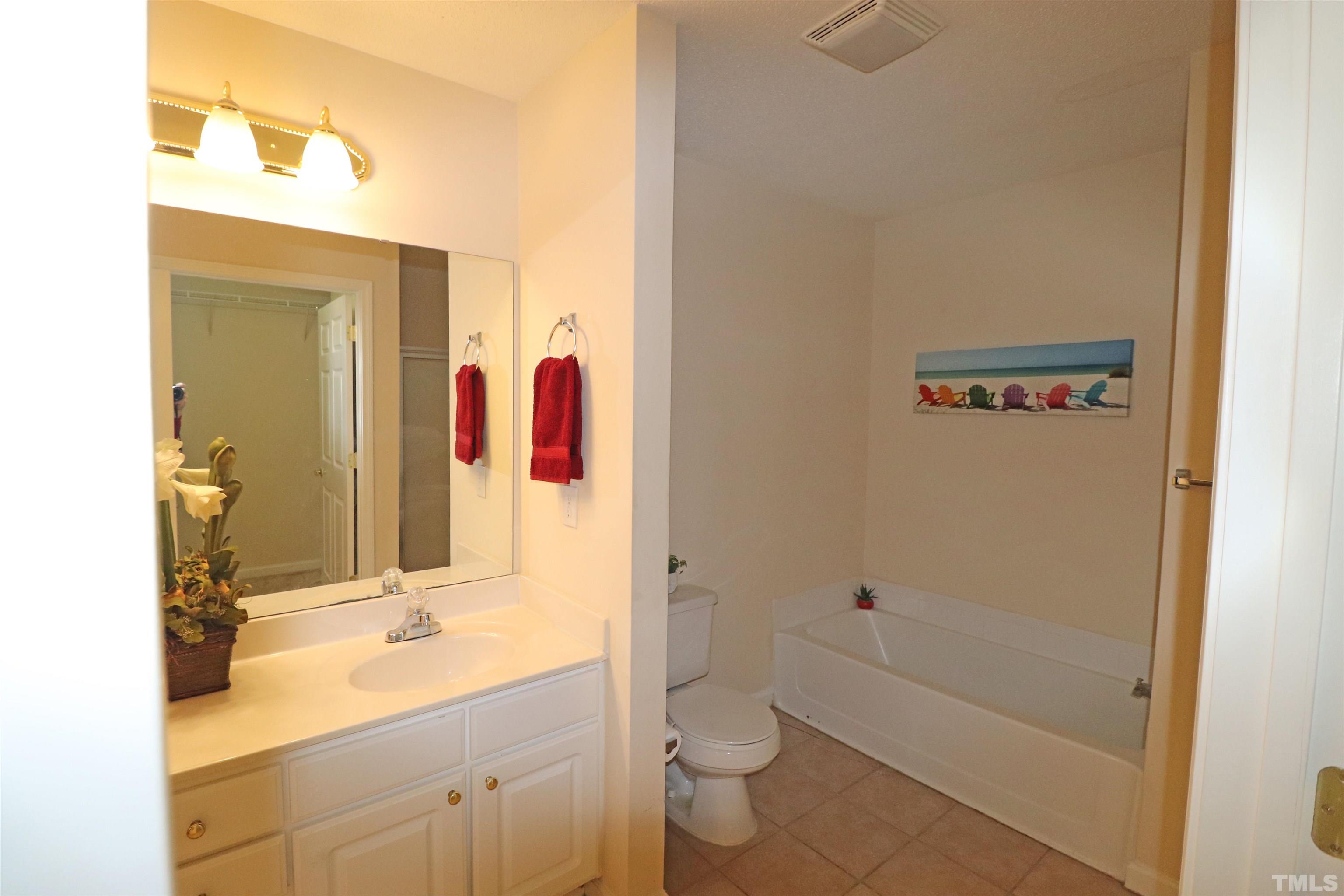 11301 Clubhaven Place, Unit 102 Raleigh, NC 27617 - Photo 39 of 53 a bathroom with a sink a toilet and shower
