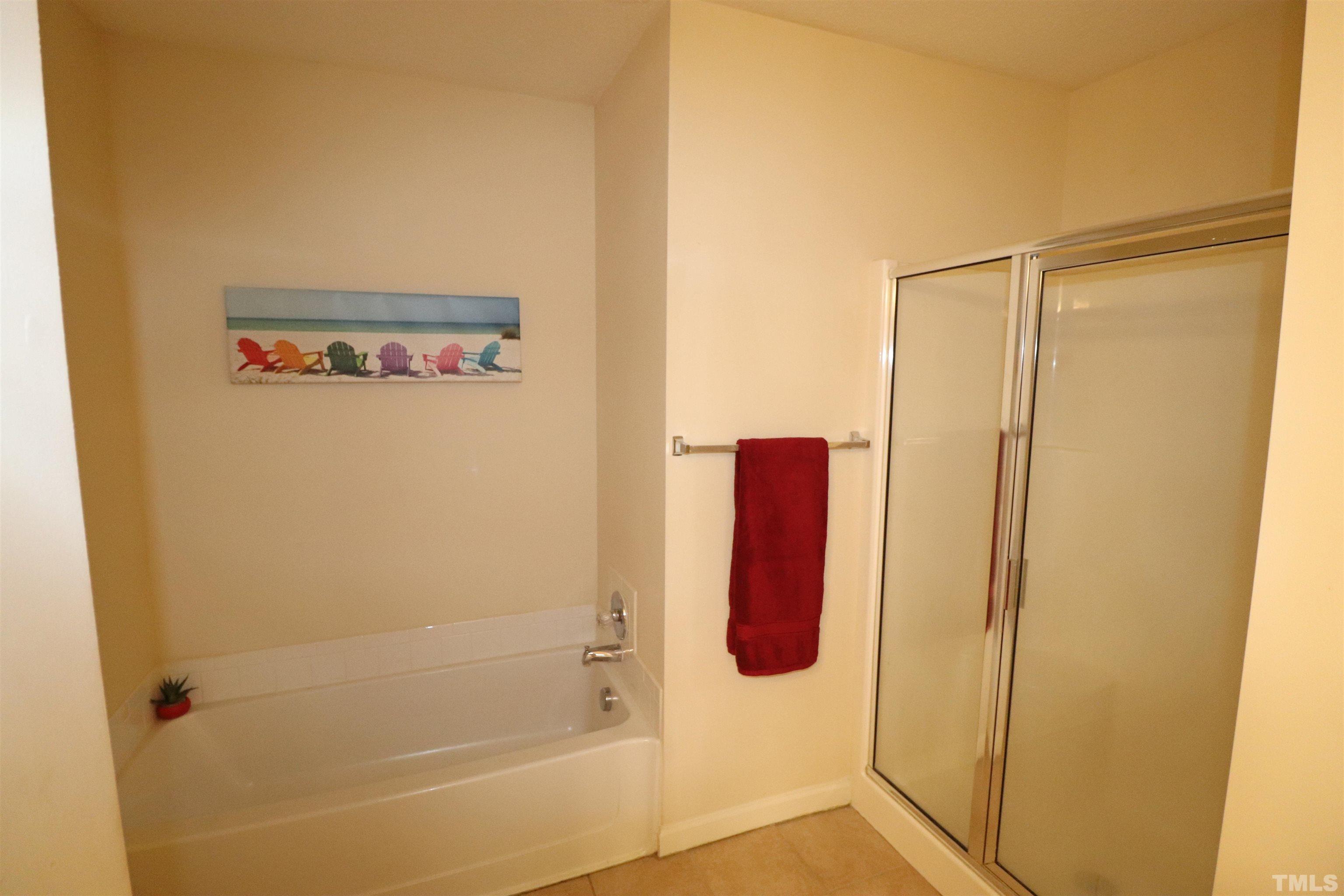 11301 Clubhaven Place, Unit 102 Raleigh, NC 27617 - Photo 40 of 53 a bathroom with a shower and a bath tub