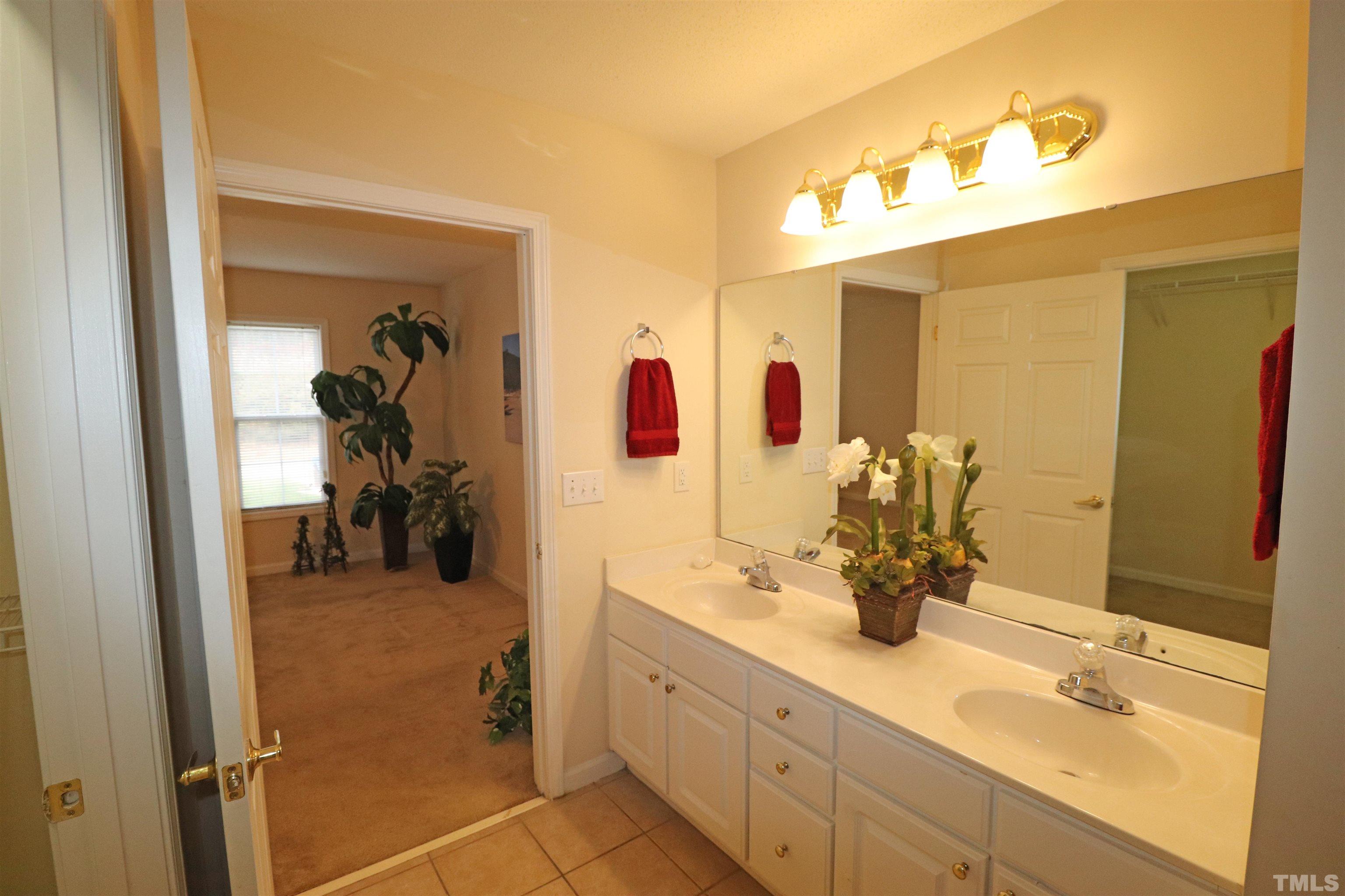 11301 Clubhaven Place, Unit 102 Raleigh, NC 27617 - Photo 41 of 53 a en suite bathroom with a double vanity sink and a mirror