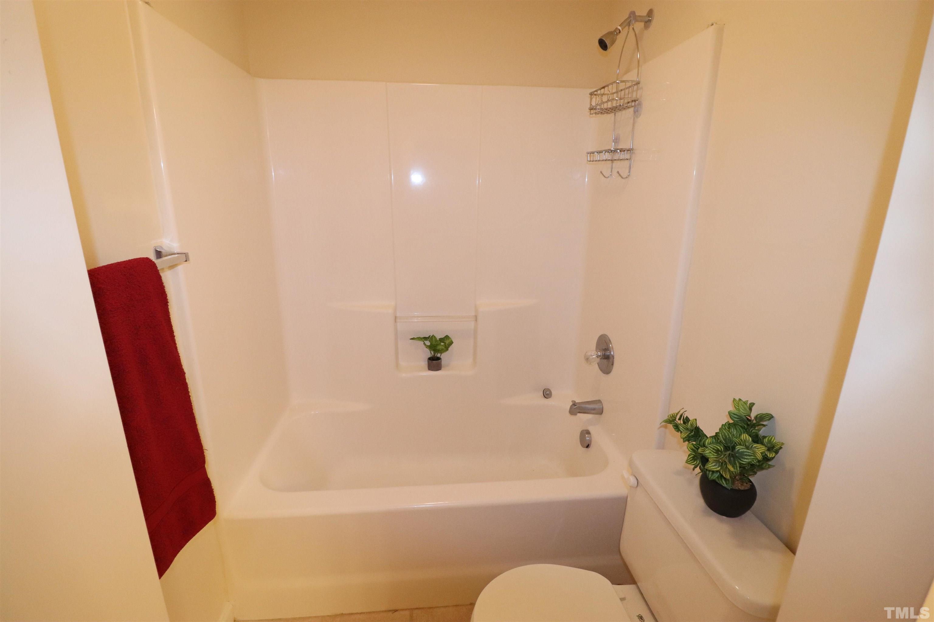 11301 Clubhaven Place, Unit 102 Raleigh, NC 27617 - Photo 46 of 53 a bathroom with a bathtub and a shower
