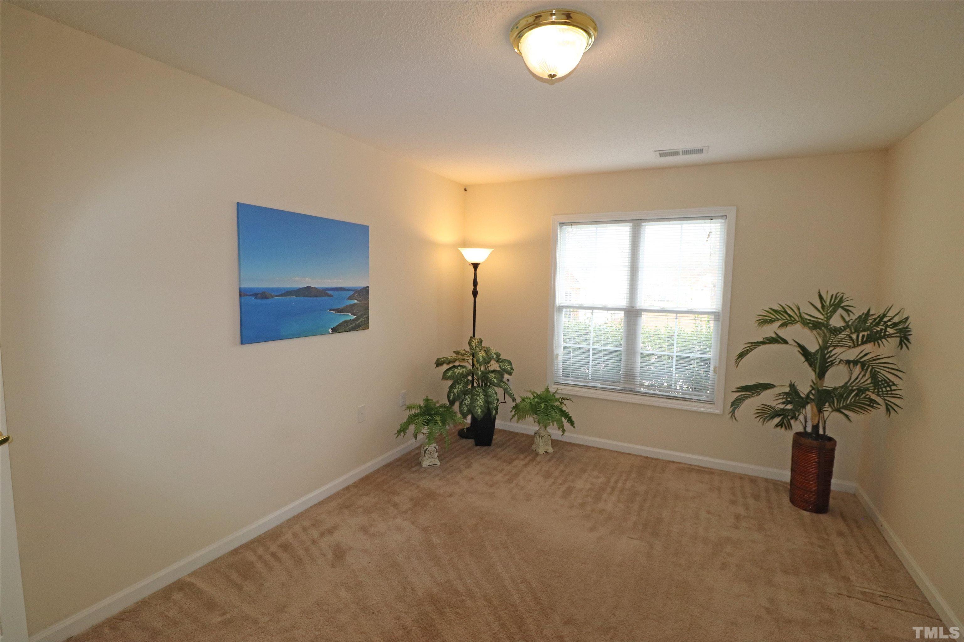 11301 Clubhaven Place, Unit 102 Raleigh, NC 27617 - Photo 51 of 53 an empty room with window and flower pot