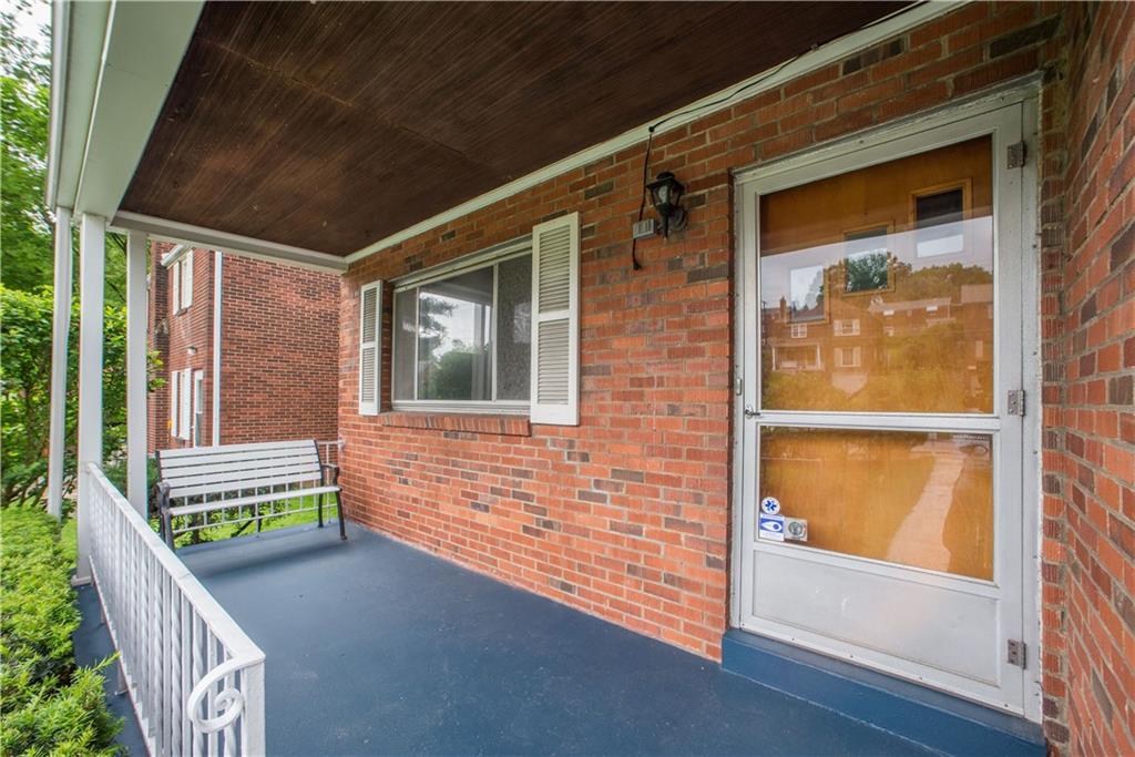 3816 West Run Road Homestead, PA 15120 - Photo 2 of 21 The covered front porch offers a welcoming entry to visitors. Wrought iron railing encloses the porch and together with the brick exterior and wooden ceiling, adds to the rustic charm found in this space.