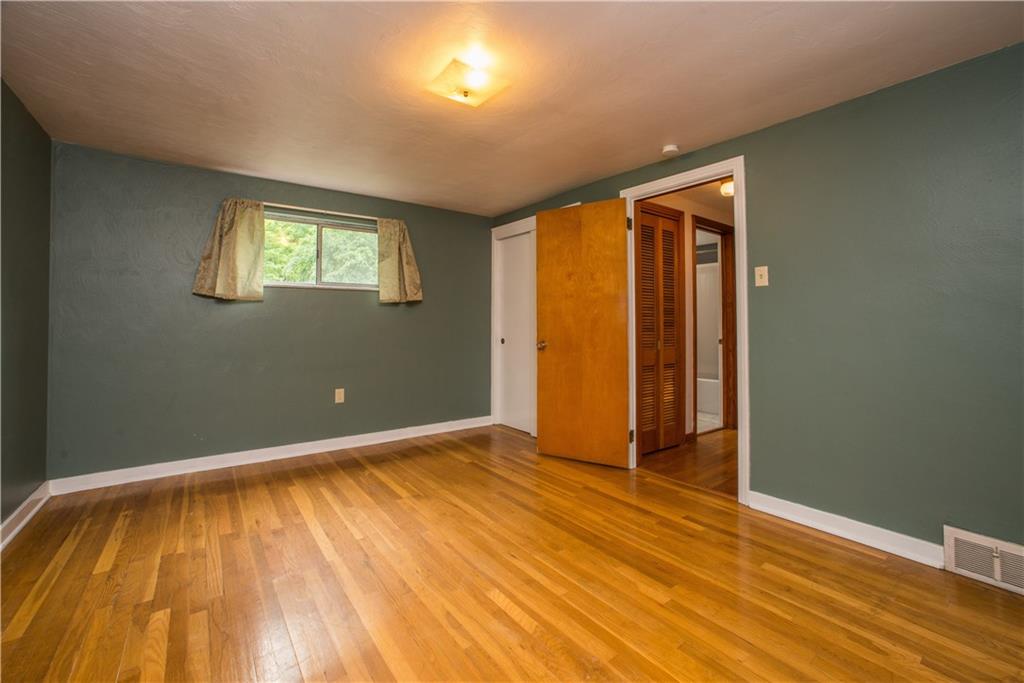 3816 West Run Road Homestead, PA 15120 - Photo 12 of 21 There are two bedrooms on the upper level. This is one of them, on the left side of the home. It is spacious (measuring 16x11), and has hardwood floor and a double closet. The full bath with hallway linen closet can be seen at right center.