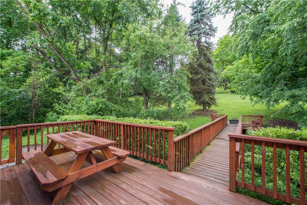 3816 West Run Road Homestead, PA 15120 - Photo 18 of 21 A backyard oasis is just steps off the kitchen! Grill and enjoy al fresco dining on the large rear deck. A quaint bridge to leads to another seating area facing the expansive, private rear yard.
