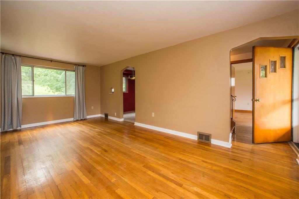 3816 West Run Road Homestead, PA 15120 - Photo 4 of 21 The living room measures a spacious 19x11, large enough to have a seating area on one end and a dining table at the other, if so desired. The window shown here faces the rear yard. The front entry can be seen on the right.