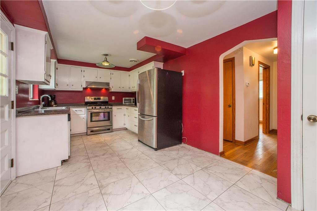 3816 West Run Road Homestead, PA 15120 - Photo 6 of 21 This is the eat-in kitchen as seen from the living area. The door on the left opens to the rear deck and back yard. Entry to the lower level is also offered in the kitchen. A linen closet is found in the hallway.