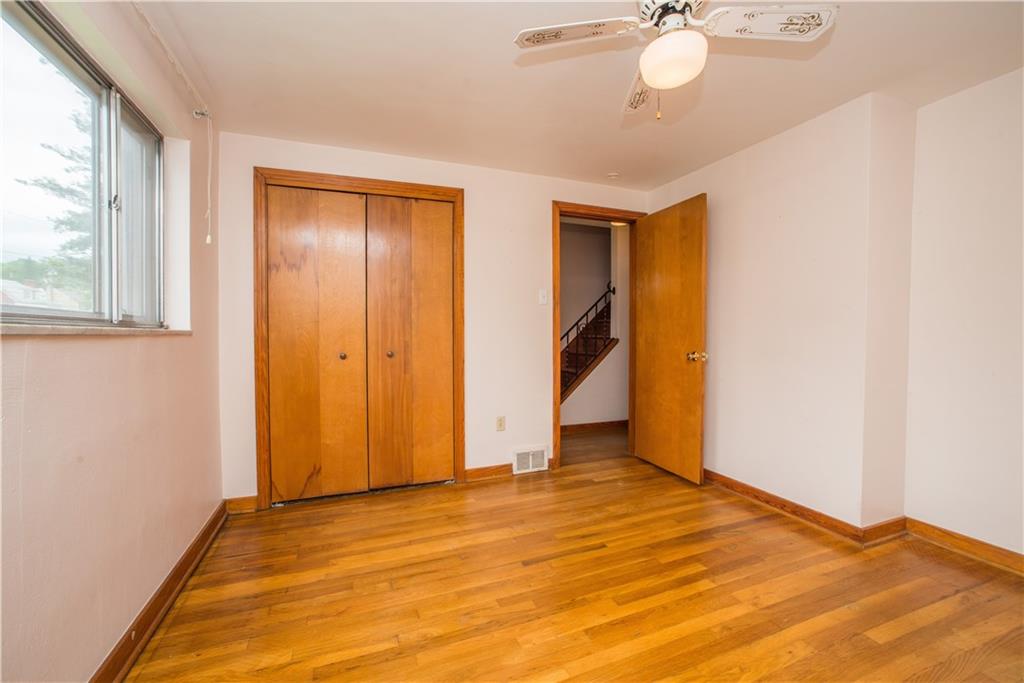 3816 West Run Road Homestead, PA 15120 - Photo 9 of 21 The first floor master bedroom has exposed hardwood floor, double closet, ceiling fan, and window overlooking the front of the home.