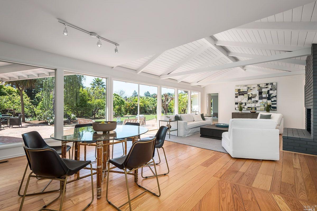 79 Lochinvar Road San Rafael, CA 94901 - Photo 1 of 1 a dining room with furniture wooden floor and a floor to ceiling window