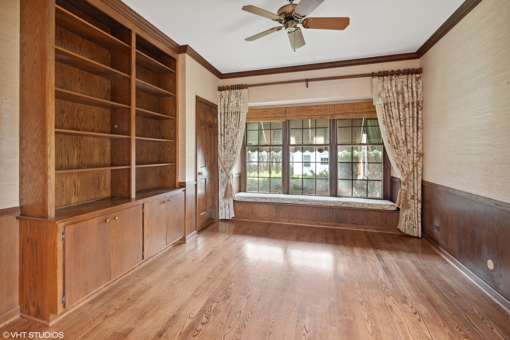 1050 South Ridge Road Lake Forest, IL 60045 - Photo 13 of 40 a view of an empty room with a window and wooden floor