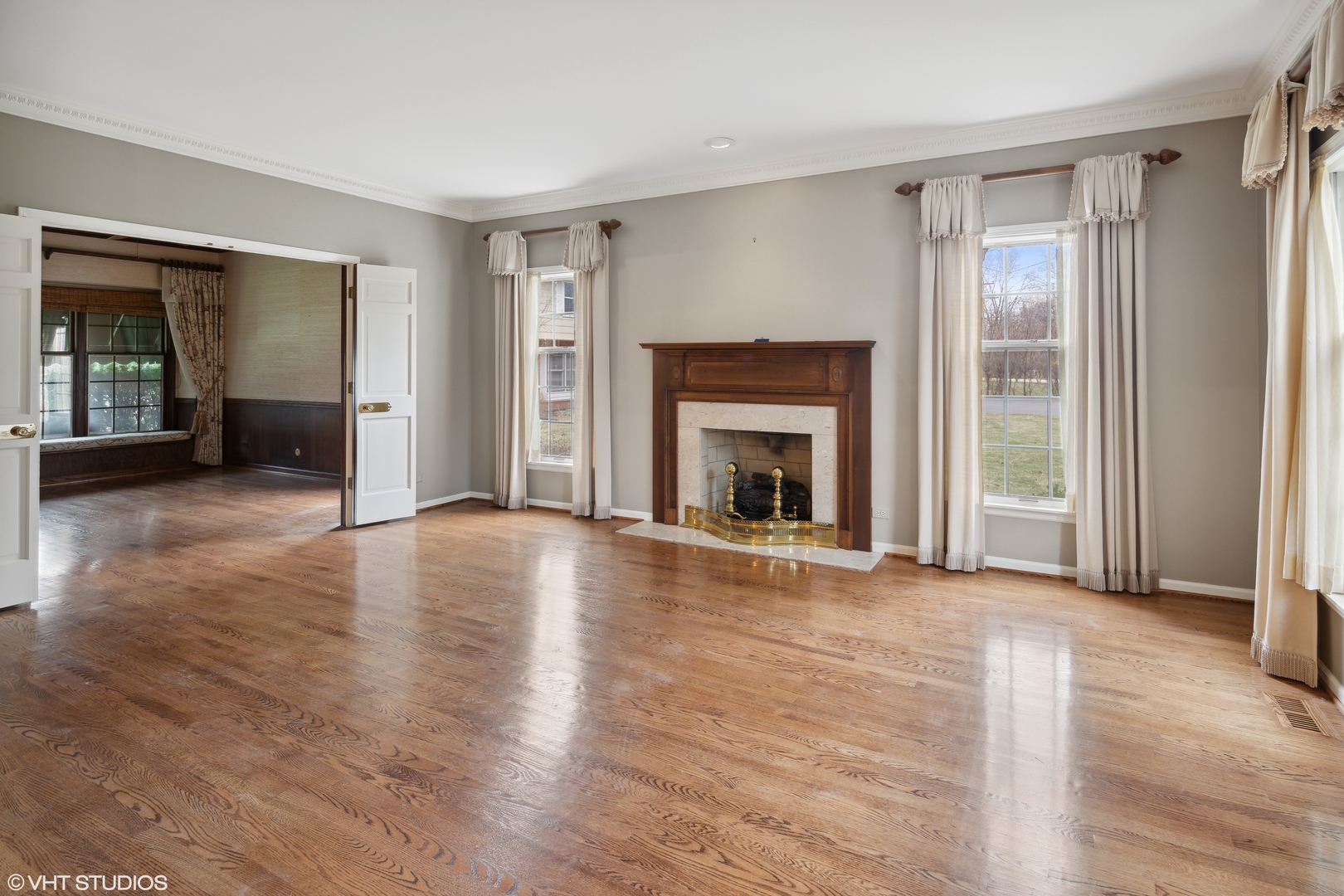 1050 South Ridge Road Lake Forest, IL 60045 - Photo 9 of 40 an empty room with wooden floor fireplace and windows