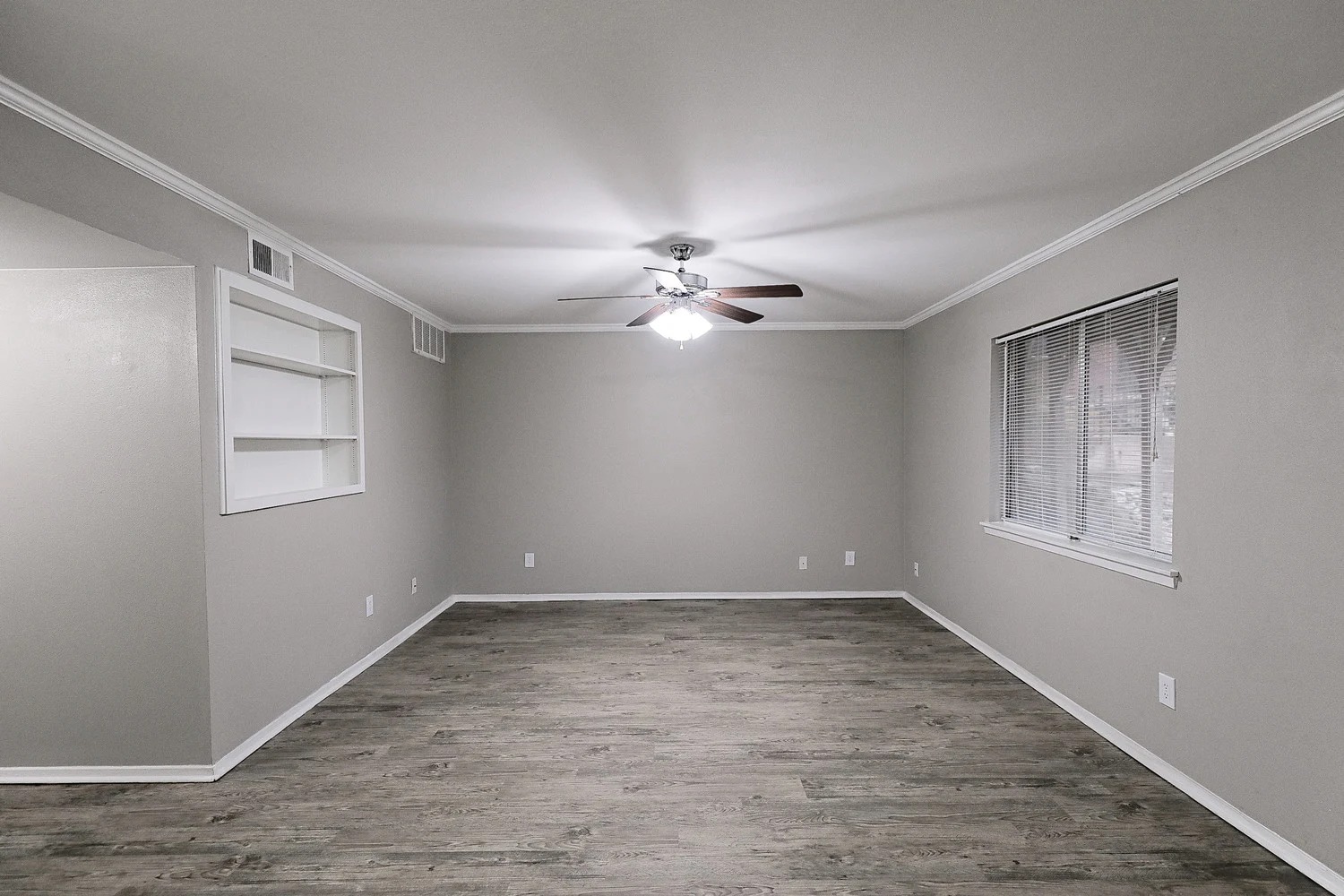 8100 North Mopac Expressway, Unit 2107 Austin, TX 78759 - Photo 14 of 23 Unfurnished room with built in shelves, light wood-style flooring, crown molding, and ceiling fan