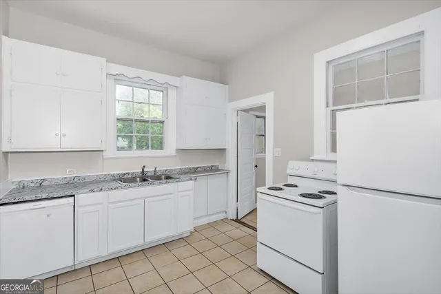 a kitchen with a stove a sink and a refrigerator
