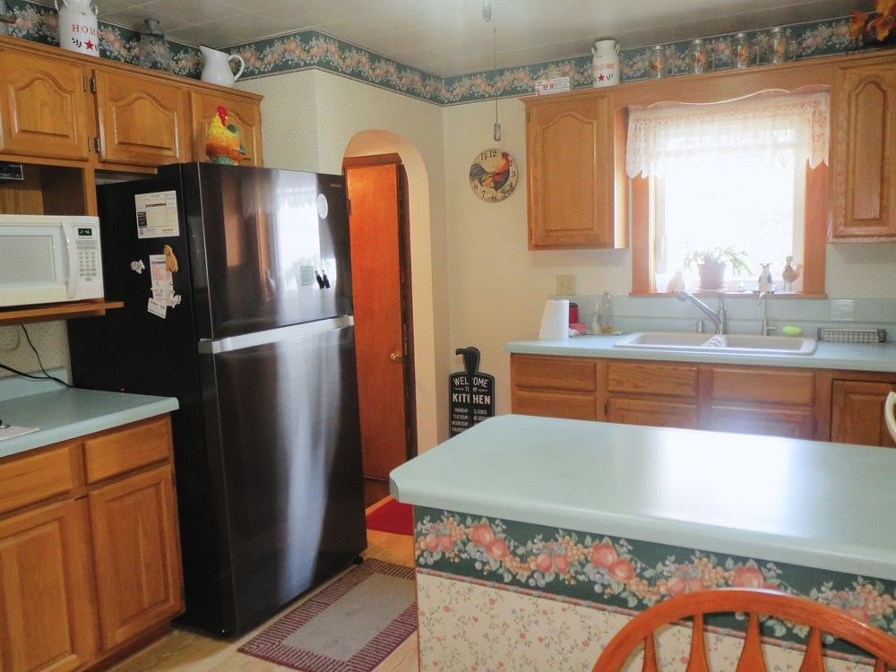 1027 Bluff Road Dixon, IL 61021 - Photo 9 of 48 a kitchen with stainless steel appliances a refrigerator and a stove