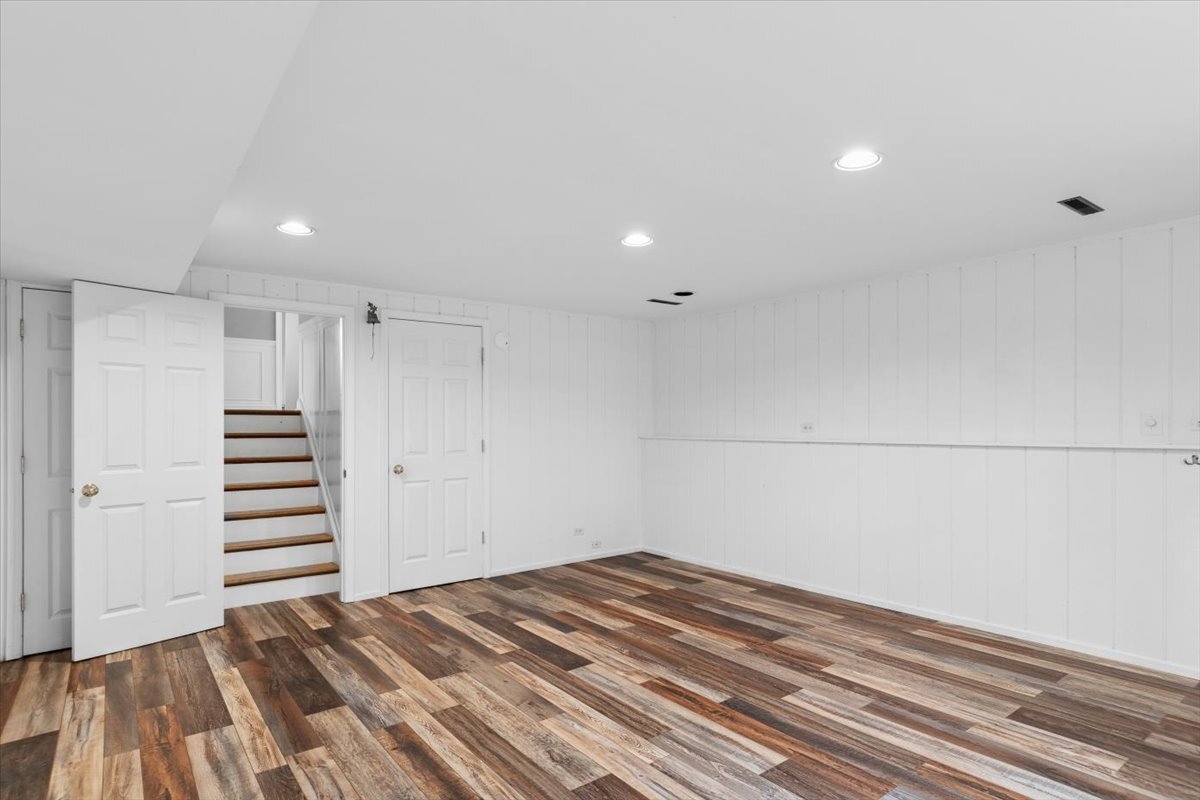 1232 Laurel Lane Naperville, IL 60540 - Photo 15 of 24 a view of a room with stairs and a ceiling fan