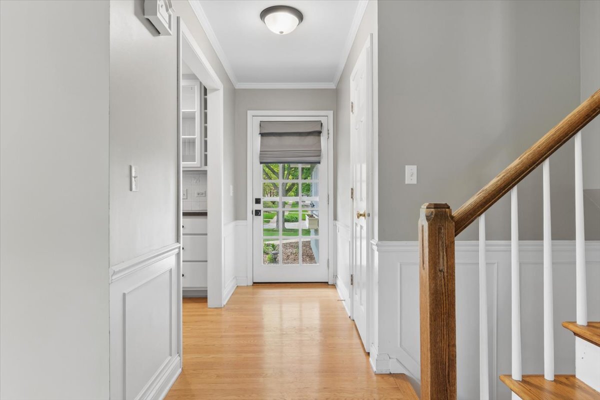 1232 Laurel Lane Naperville, IL 60540 - Photo 17 of 24 a view of a hallway with wooden floor and stairs