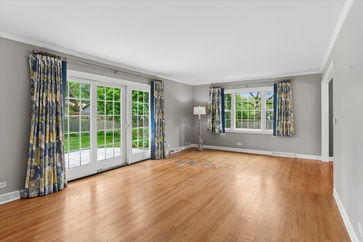 1232 Laurel Lane Naperville, IL 60540 - Photo 5 of 24 a view of an empty room with wooden floor and a window