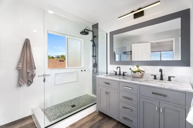 a bathroom with a granite countertop sink mirror and vanity
