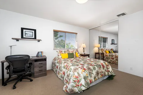 a bedroom with a bed and a desk