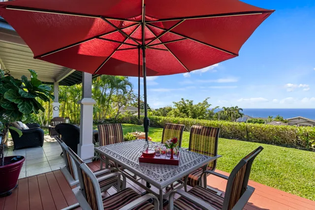 a view of an outdoor sitting area with furniture and umbrella