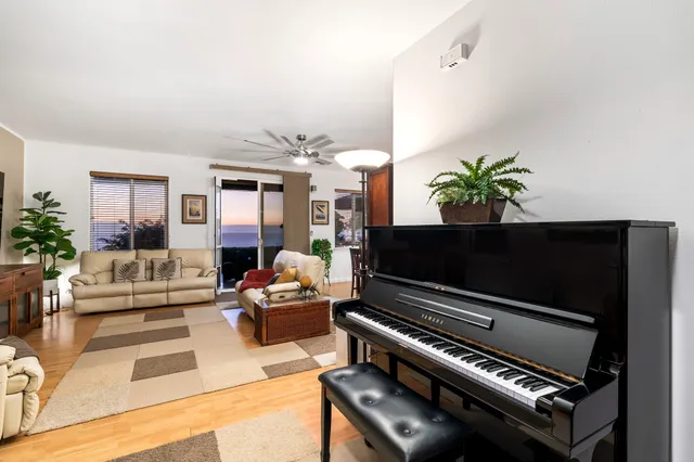 a living room with furniture and a piano