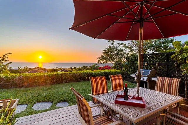 a view of deck with dinning table and chair under an umbrella