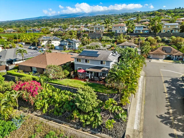 an aerial view of a houses with a yard