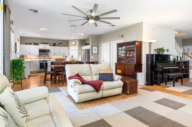 a living room with furniture and kitchen view
